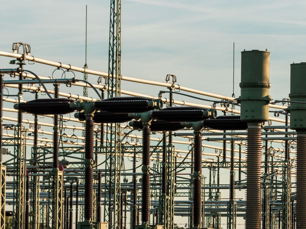 High-voltage substation switchyard with insulators, busbars and transformers